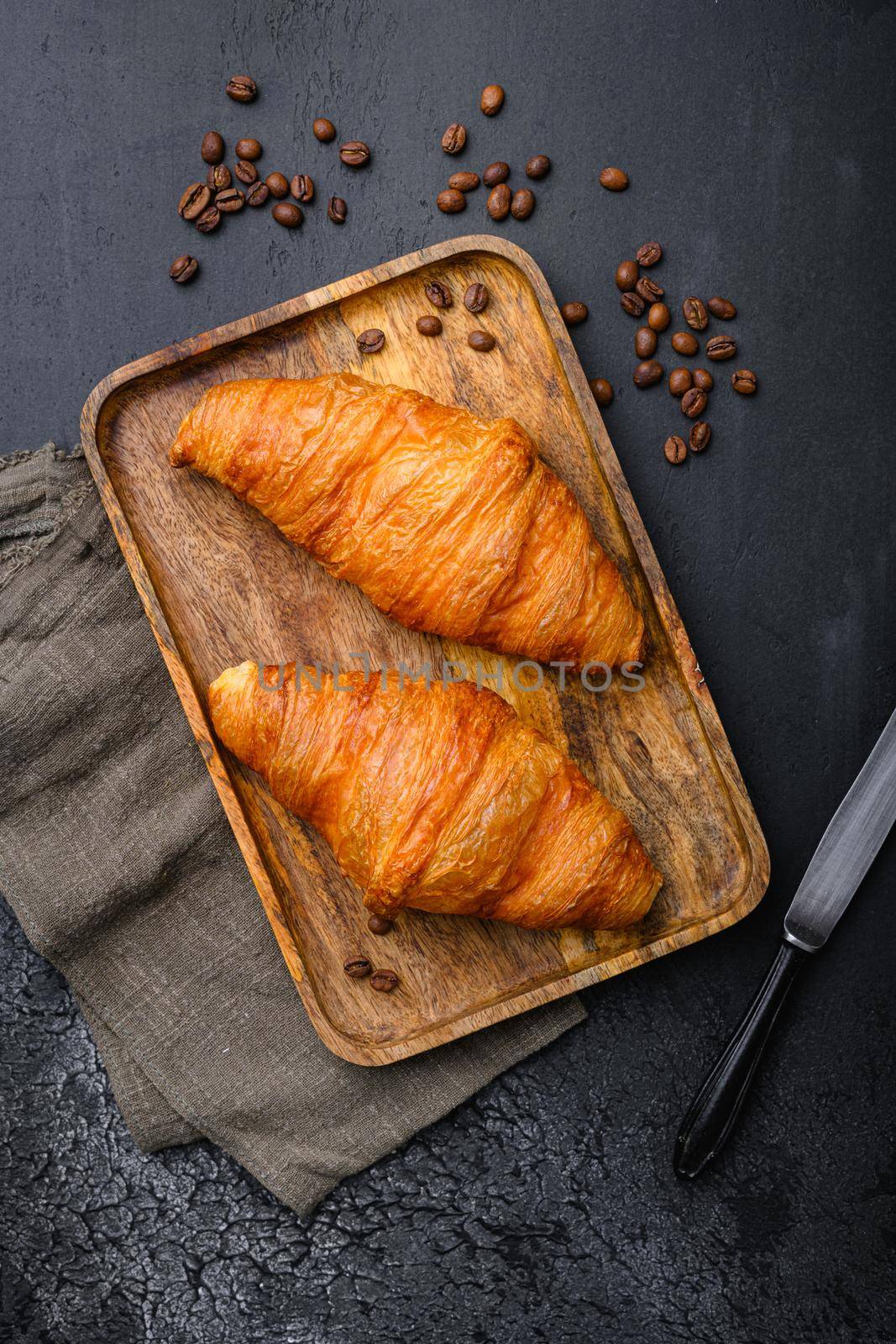 Fresh baked croissant set, on black dark stone table background, top view flat lay by Ilianesolenyi