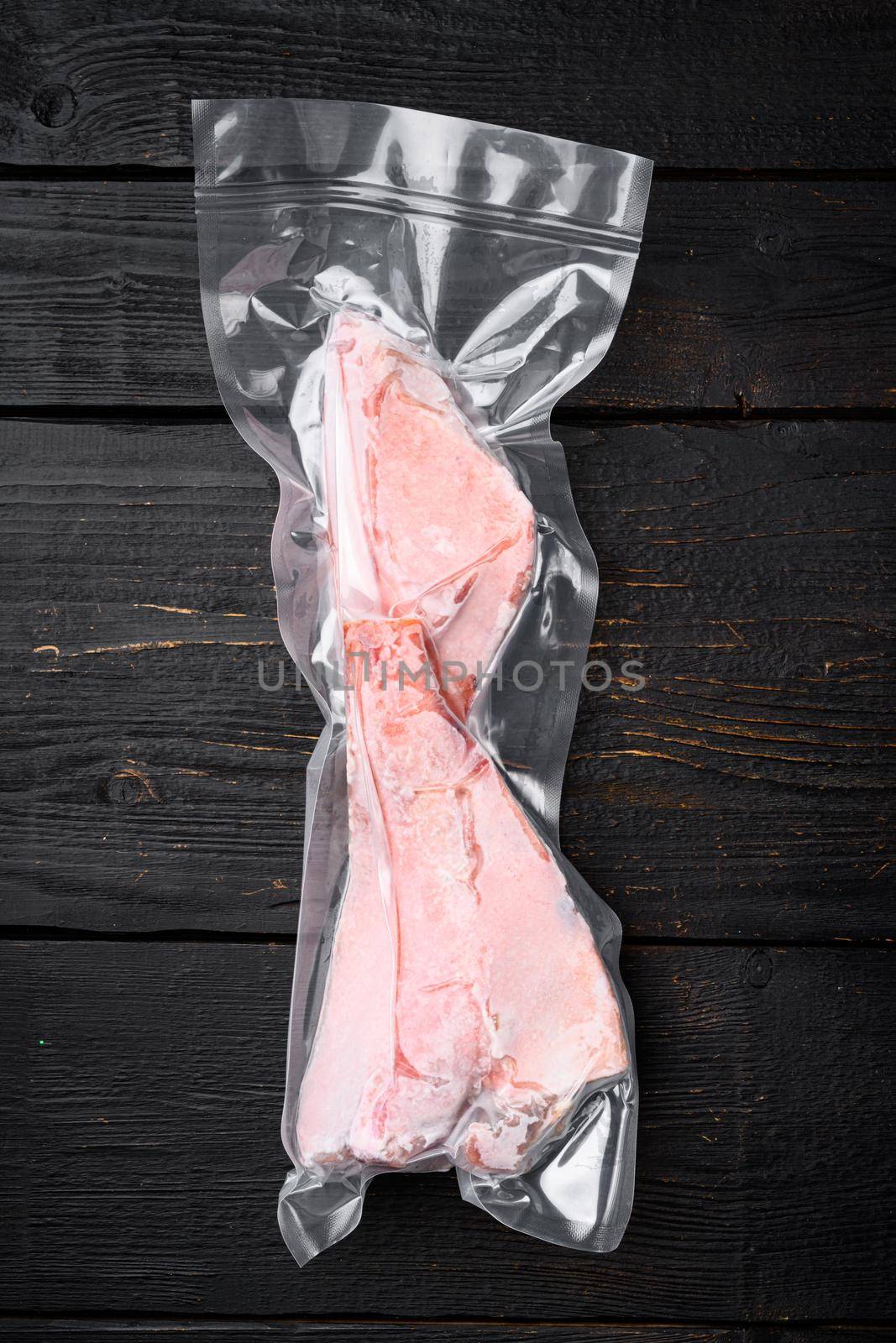 Orange roughy frozen pack fish meat set, on black wooden table background, top view flat lay