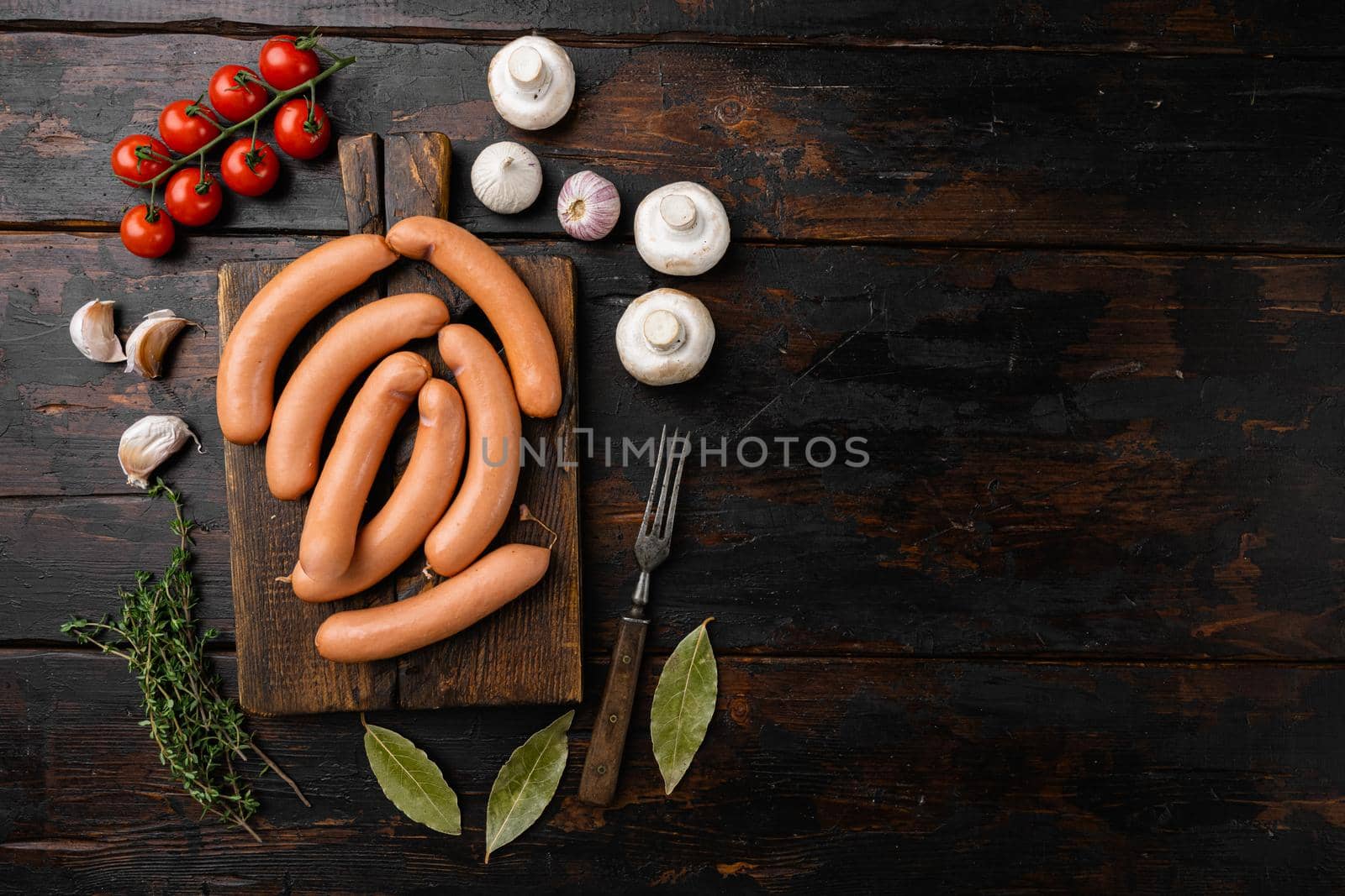 Sausages, on old dark wooden table background, top view flat lay, with copy space for text