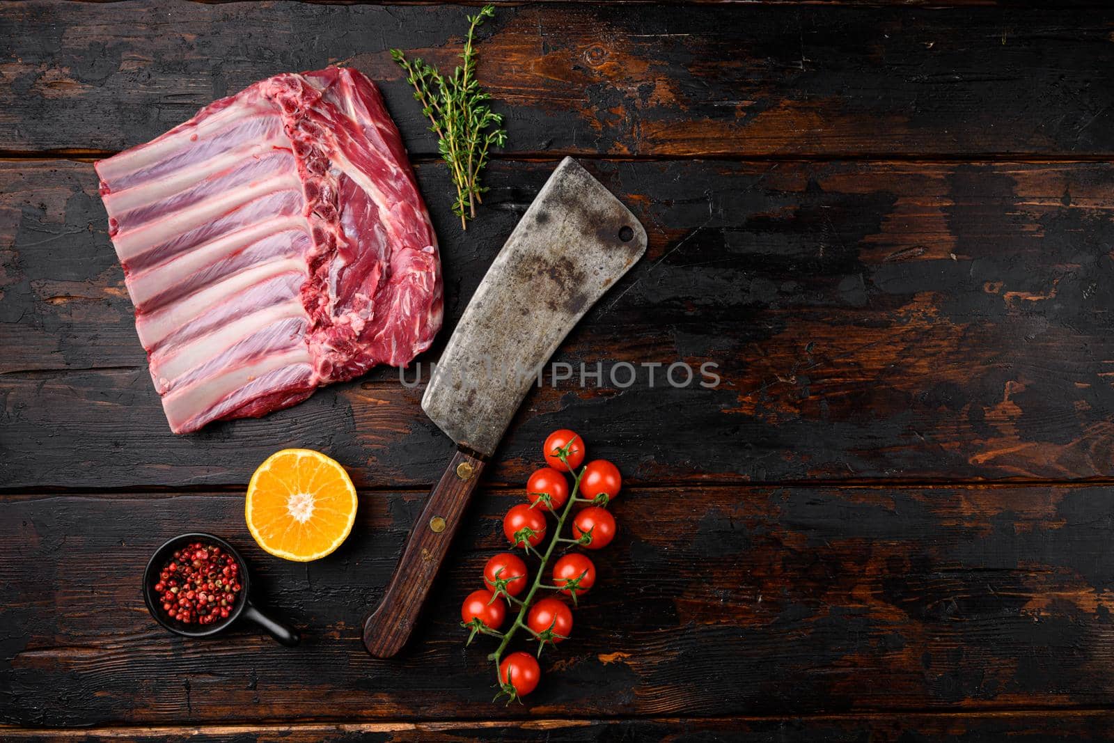 Lamb meat rib rack set, on old dark wooden table background, top view flat lay, with copy space for text