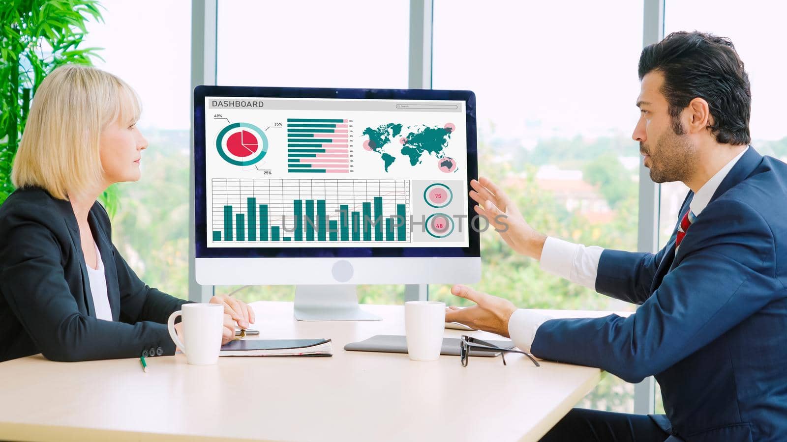 Business data dashboard analysis by ingenious computer software . Investment application display business sales and profit on the computer screen and advise marketing planning decision .