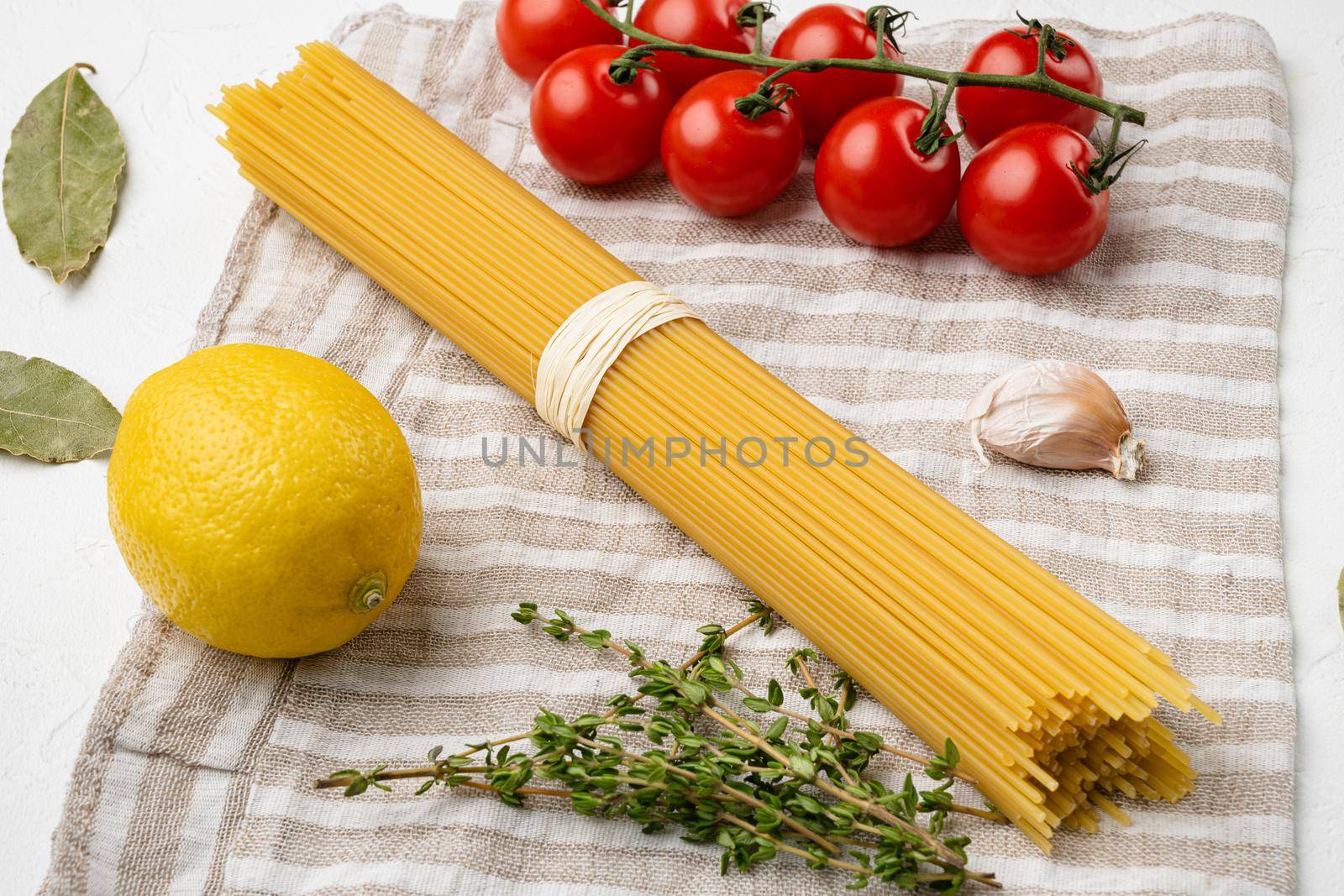 Raw ingredients for cooking italian pasta, on white stone table background by Ilianesolenyi