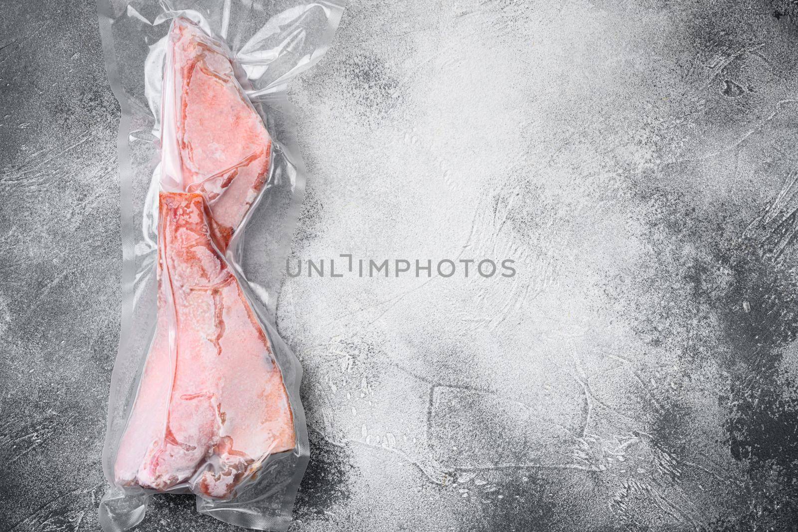 Orange roughy frozen pack fish meat set, on gray stone table background, top view flat lay, with copy space for text