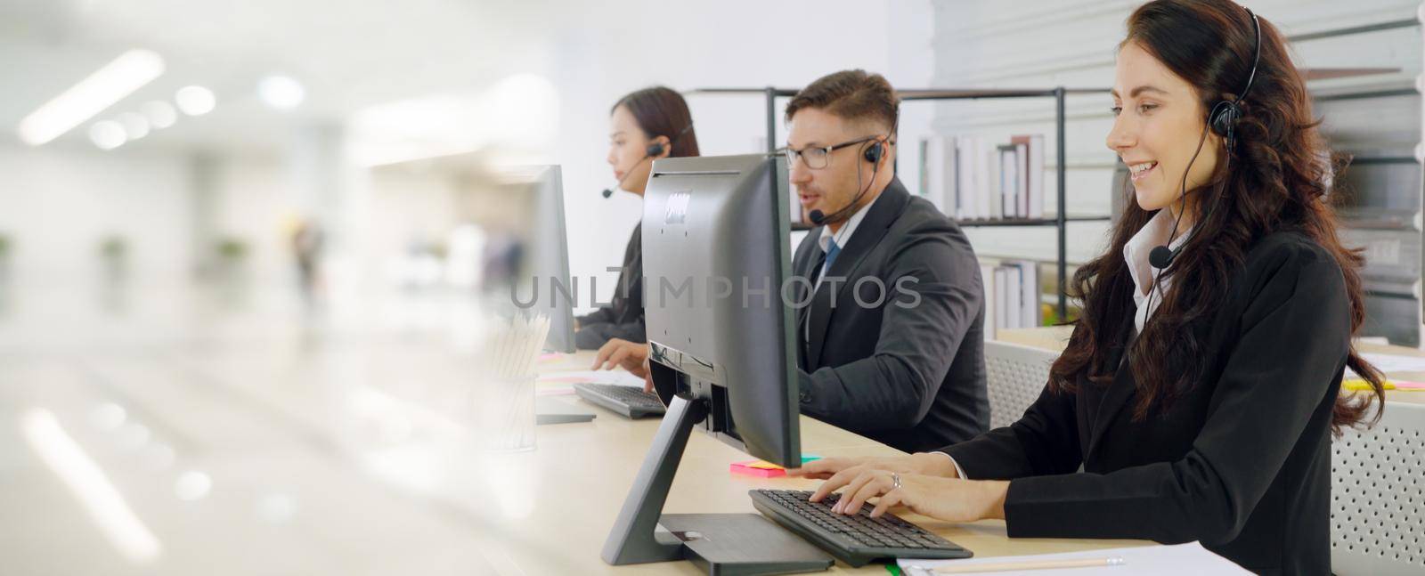 Business people wearing headset working in office to support remote customer or colleague. Call center, telemarketing, customer support agent provide service in broaden view .