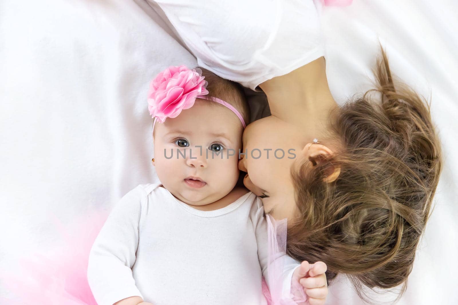 Baby girl with her older sister. Selective focus.