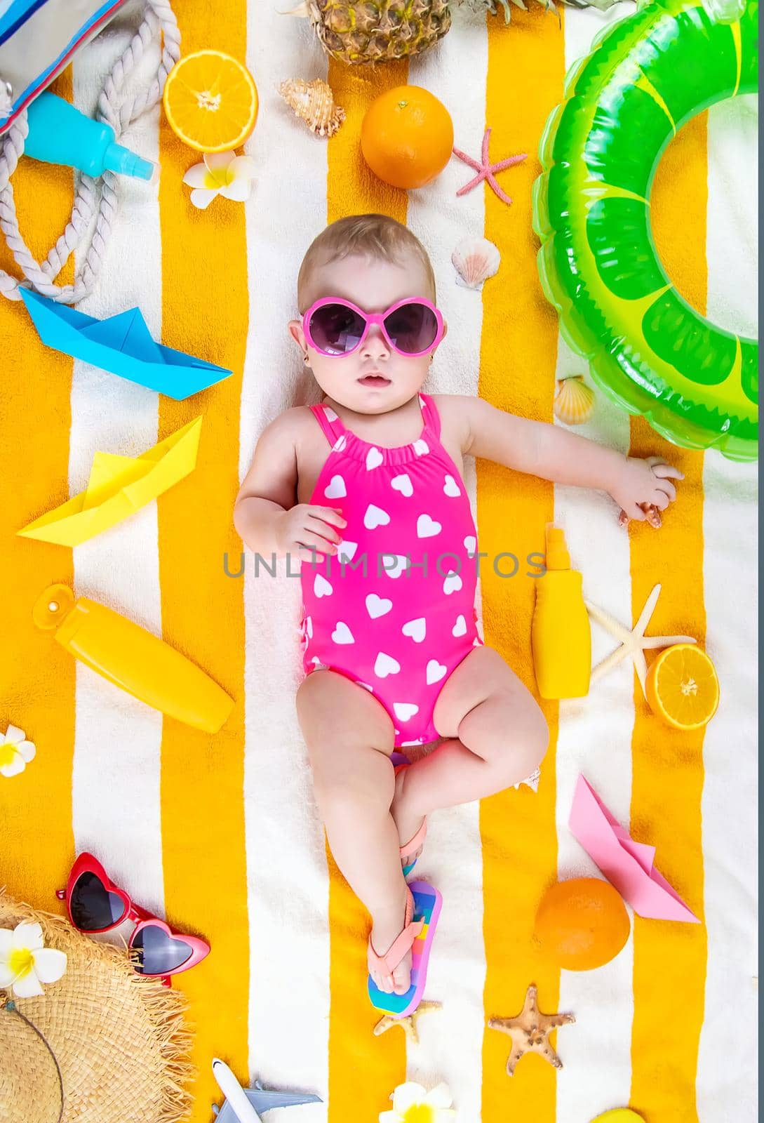 Baby on a beach towel at the sea. Selective focus. Child.