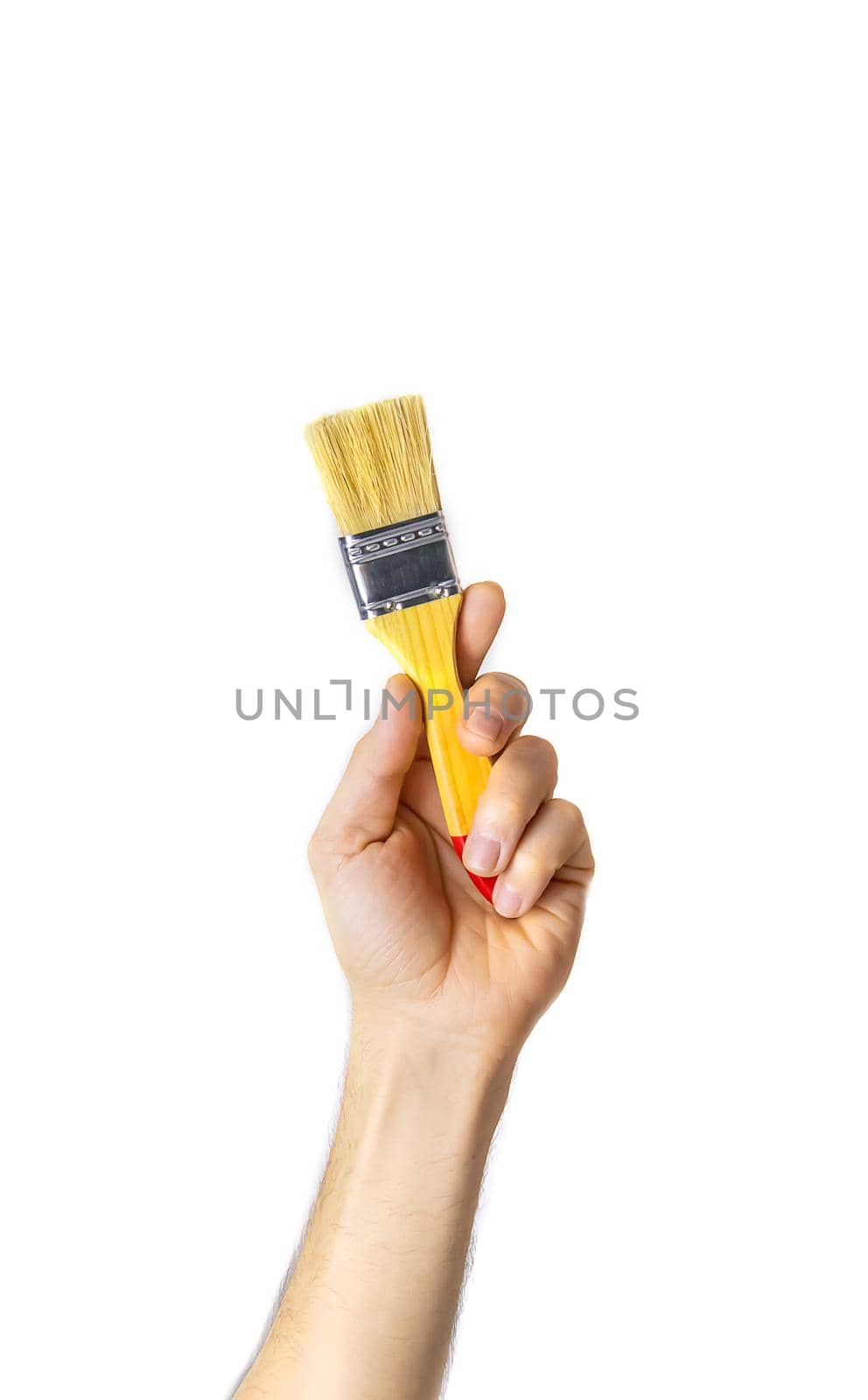 repair brush in the hands of a male isolate. Selective focus. People.