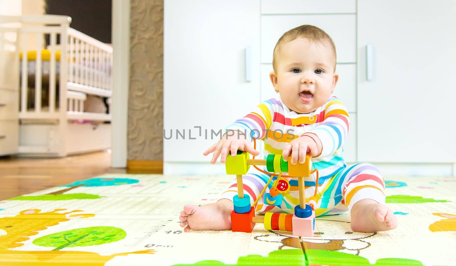 Baby plays with an educational toy. Selective focus. Child.