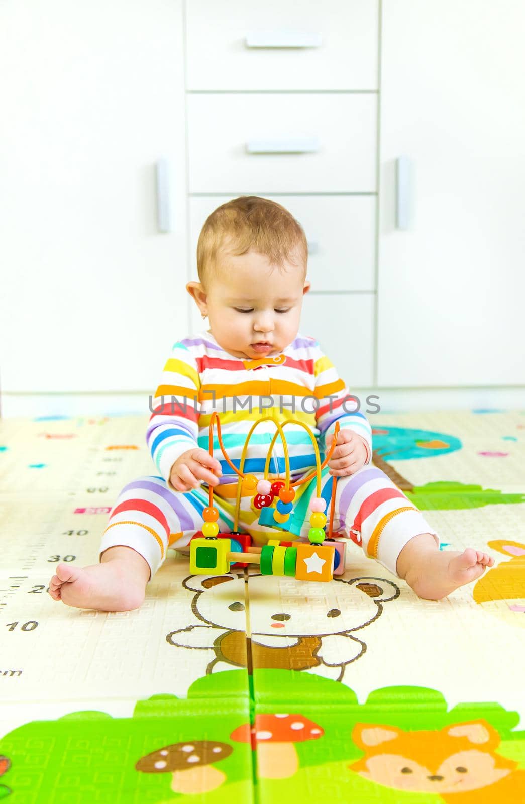 Baby plays with an educational toy. Selective focus. Child.