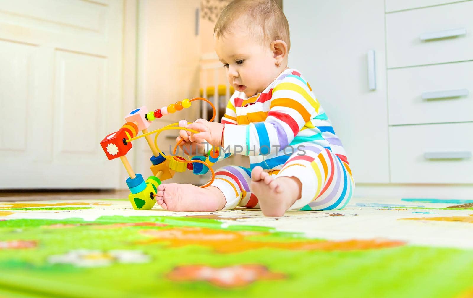 Baby plays with an educational toy. Selective focus. Child.