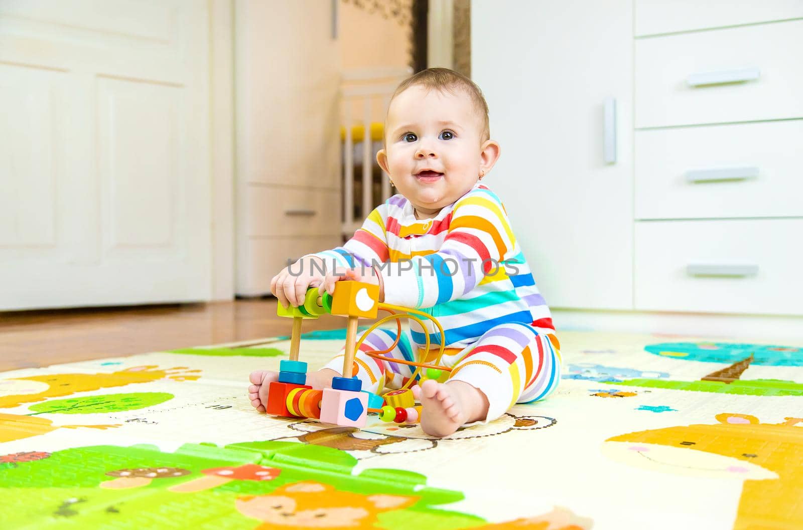 Baby plays with an educational toy. Selective focus. by yanadjana