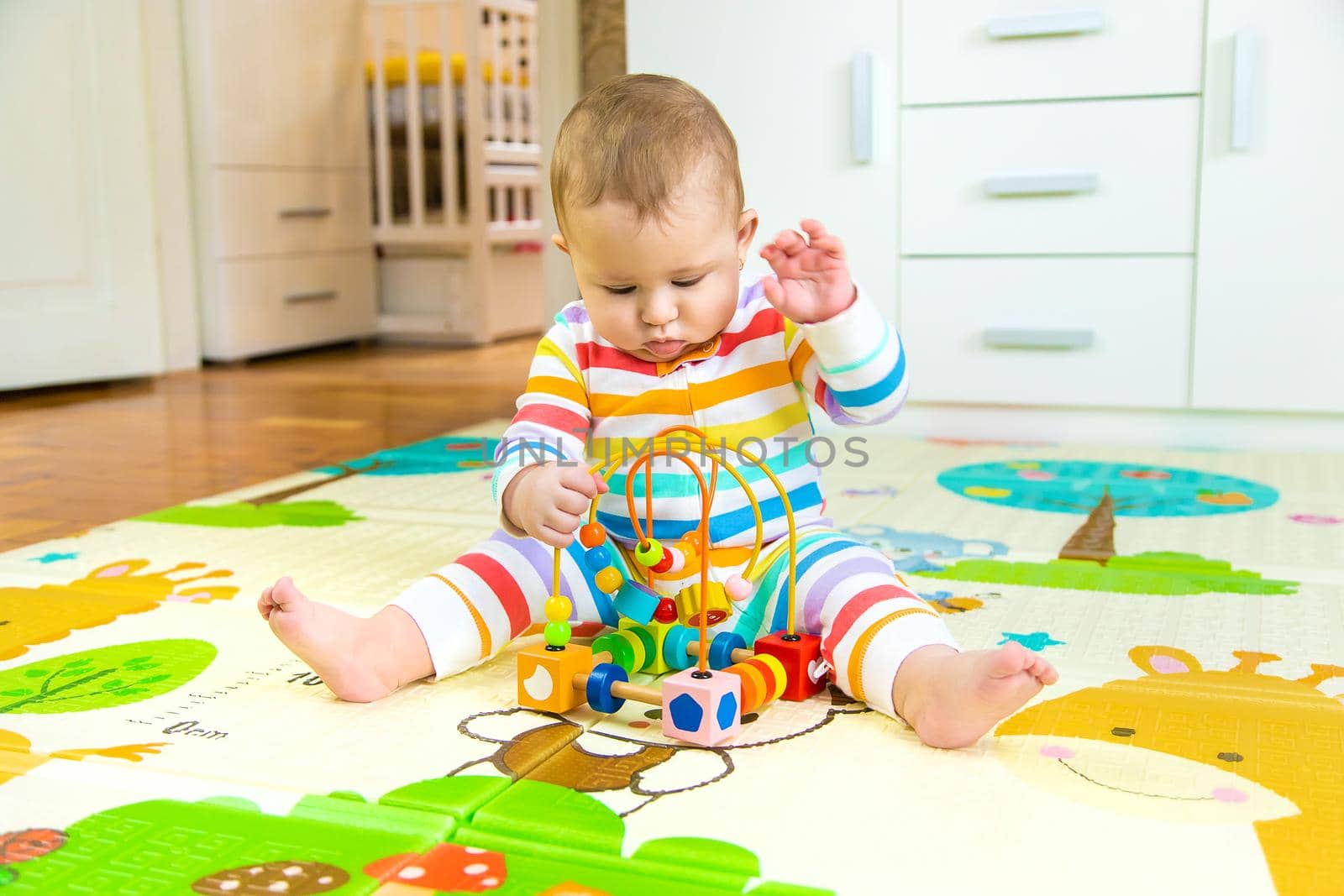 Baby plays with an educational toy. Selective focus. by yanadjana