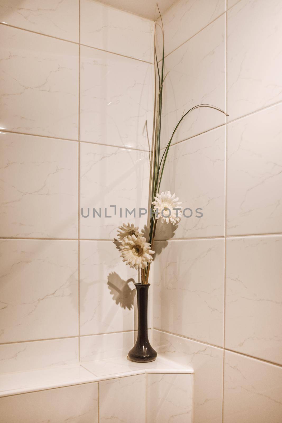 Flowers in a vase as a decor for the bathroom