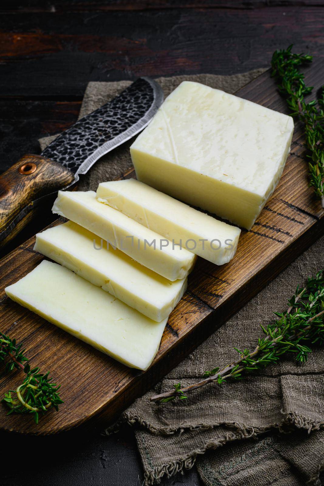 Halloumi Cheese fresh cut set, on old dark wooden table background by Ilianesolenyi