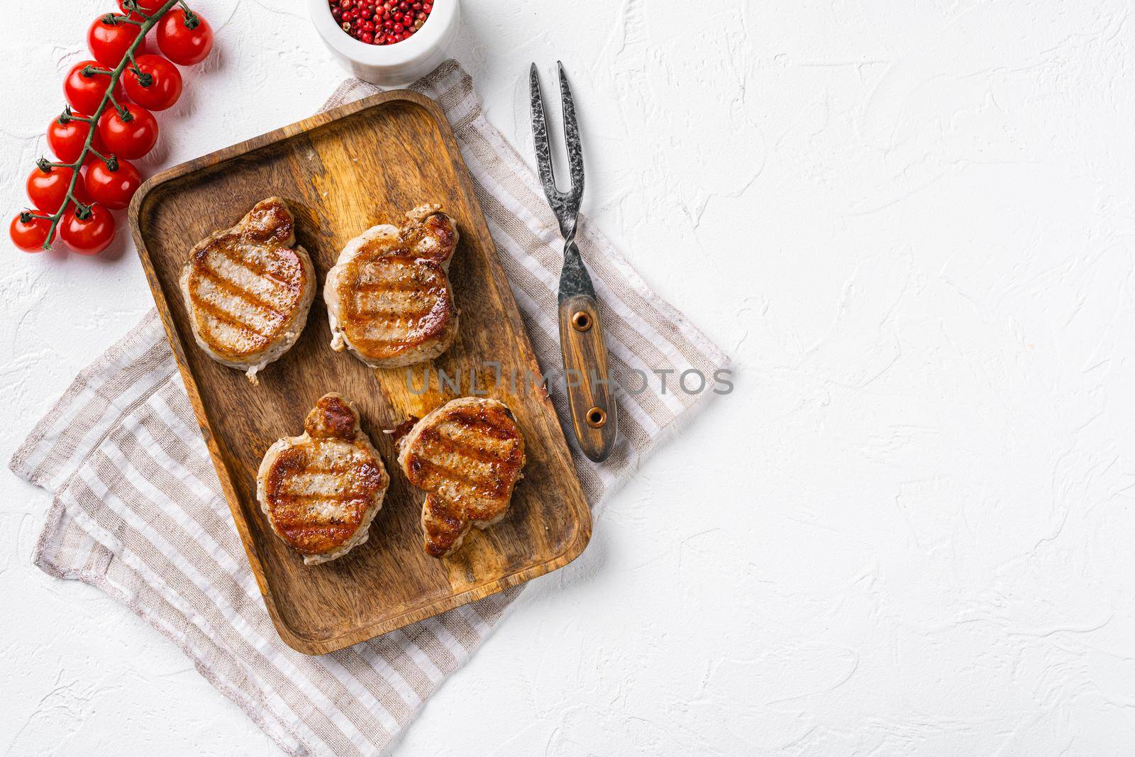 Grilled pork fillet meat set, on white stone table background, top view flat lay, with copy space for text by Ilianesolenyi