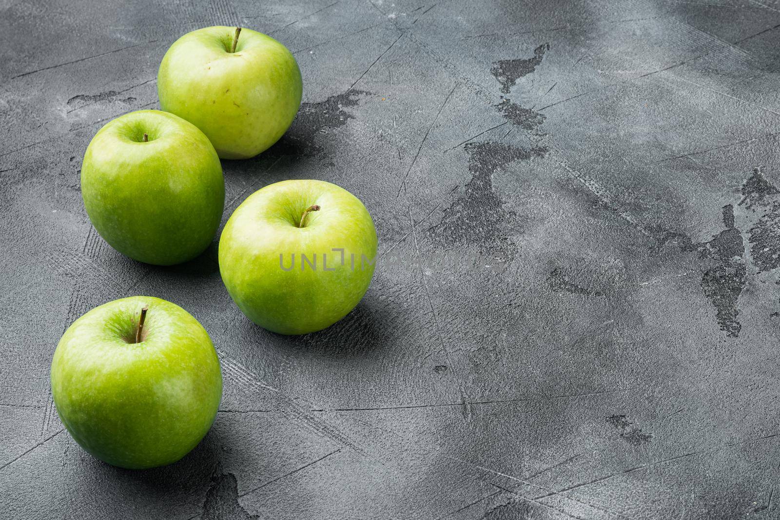 Ripe green apples set, on gray stone table background, with copy space for text