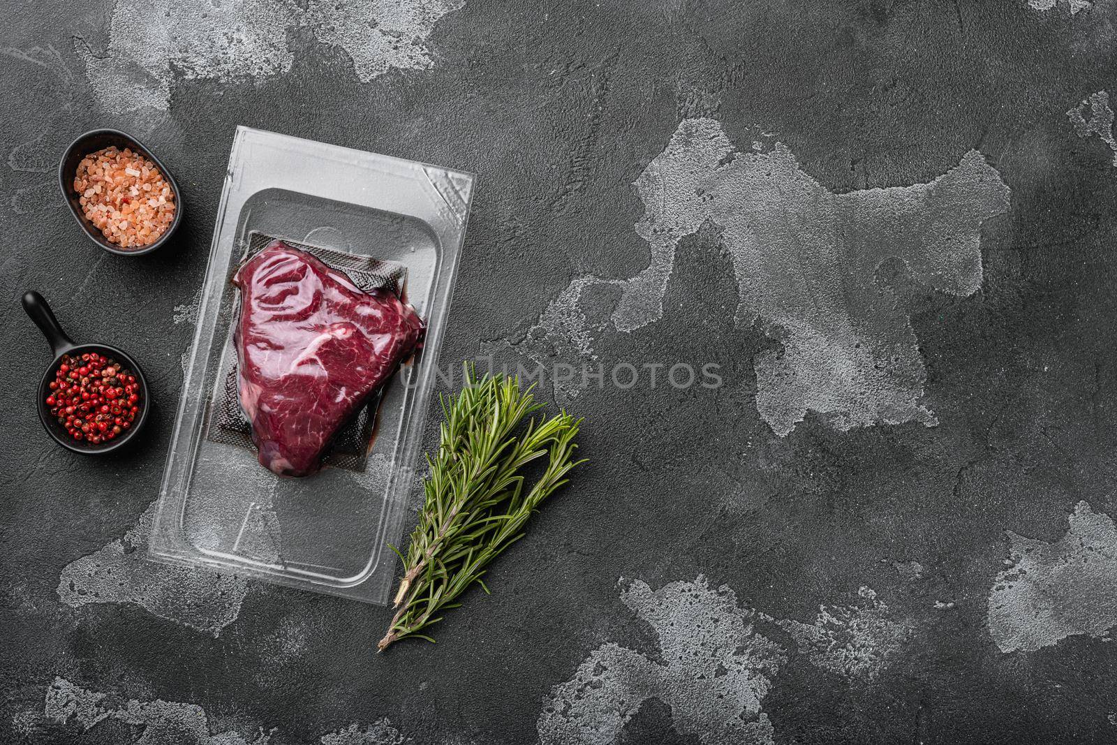 Market pack with raw rump beef steak set, on black dark stone table background, top view flat lay, with copy space for text