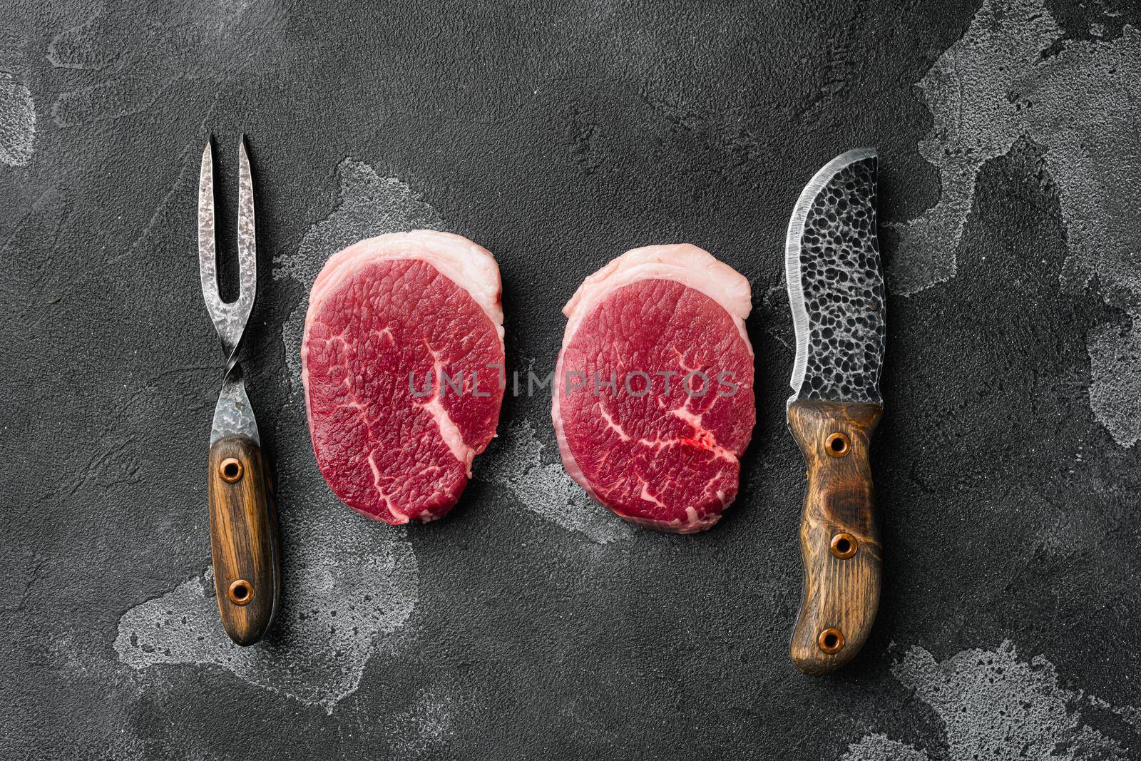 Fresh beef steak sliced set, on black dark stone table background, top view flat lay