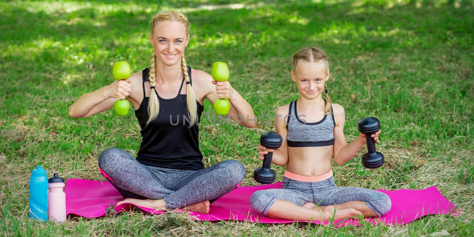 Young woman and girl are training with dumbbells by okskukuruza