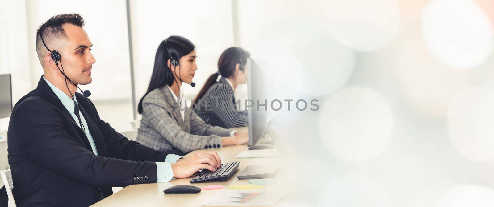 Business people wearing headset working in office broaden view by biancoblue