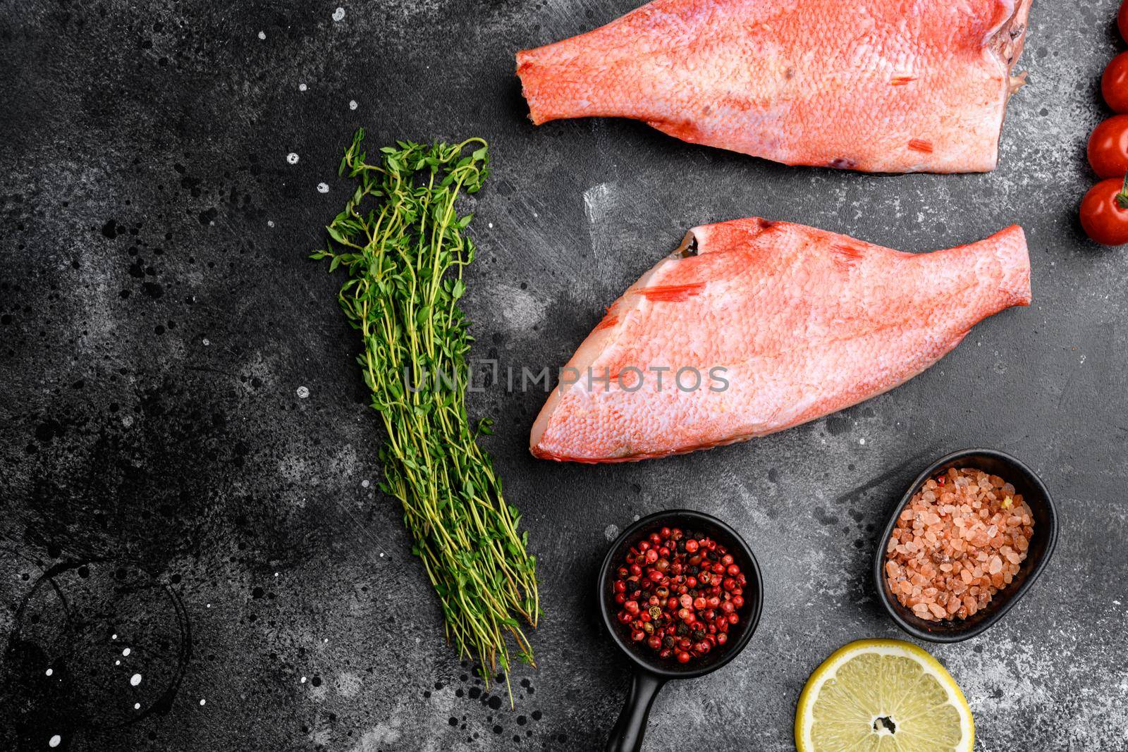 Fresh sea ocean red perch fish set, on black dark stone table background, top view flat lay, with copy space for text