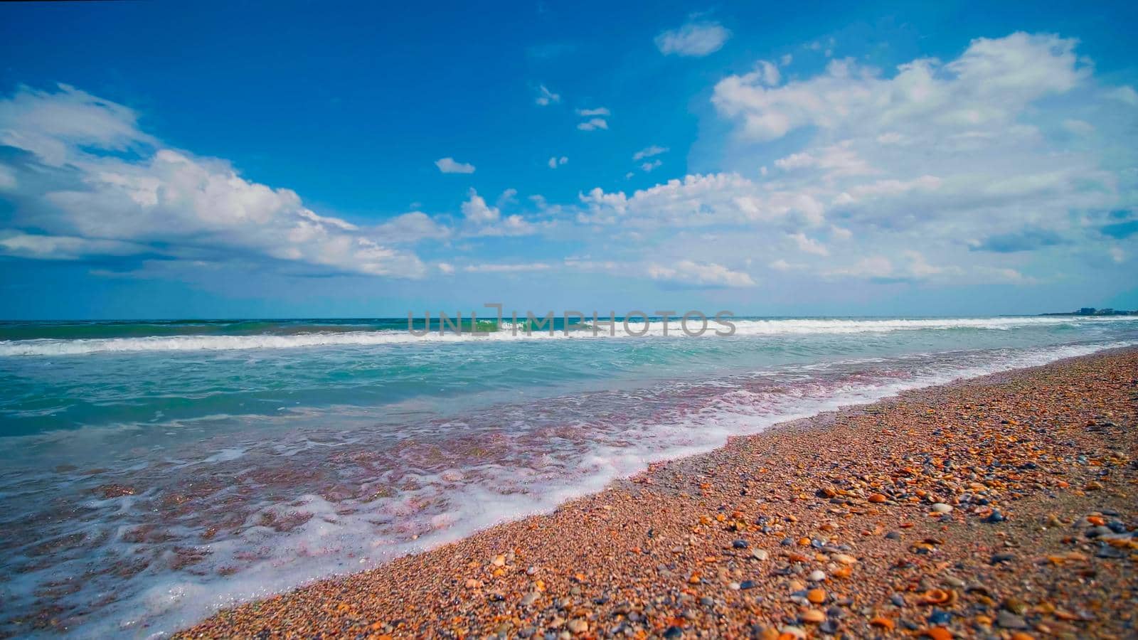 Black Sea waves in sunny day. Beautiful seascape. View from Seashore, blue sky, summer landscape at the sea.