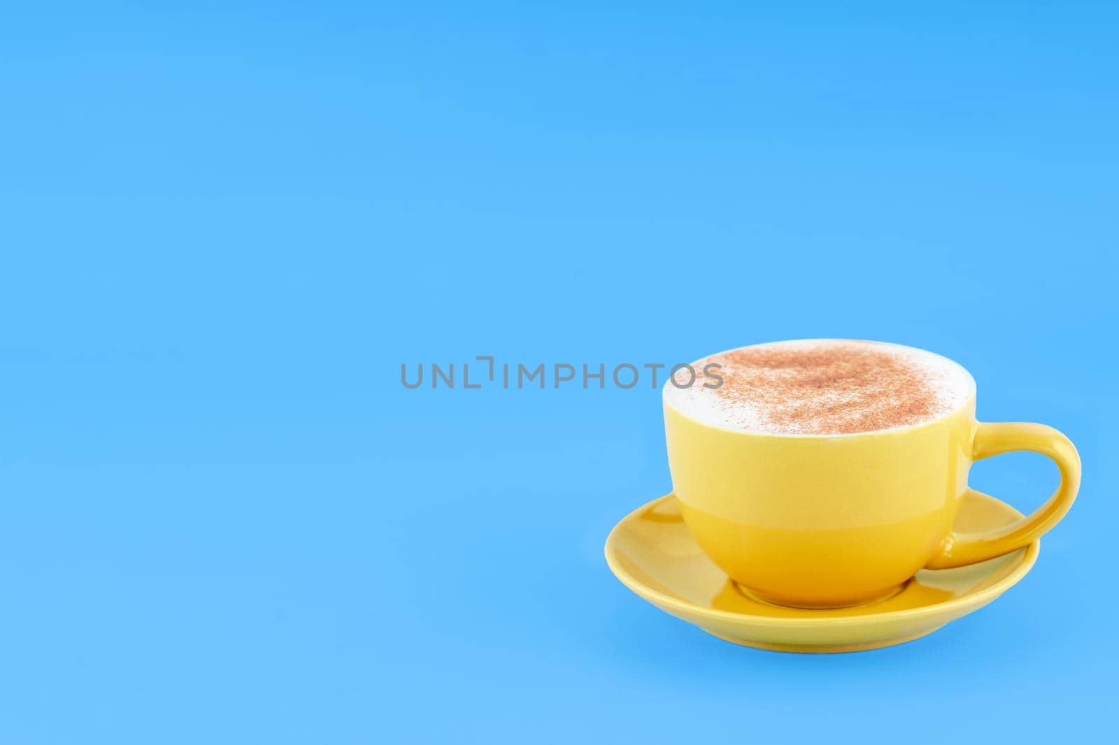 yellow cup of coffee on blue background Space for text by Iryna_Melnyk