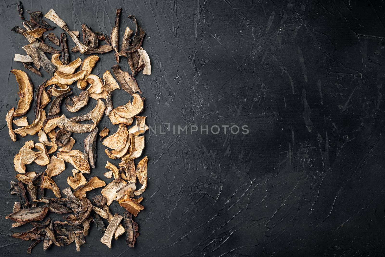 Dried porcini mushrooms set, on black background, top view flat lay , with space for text copyspace