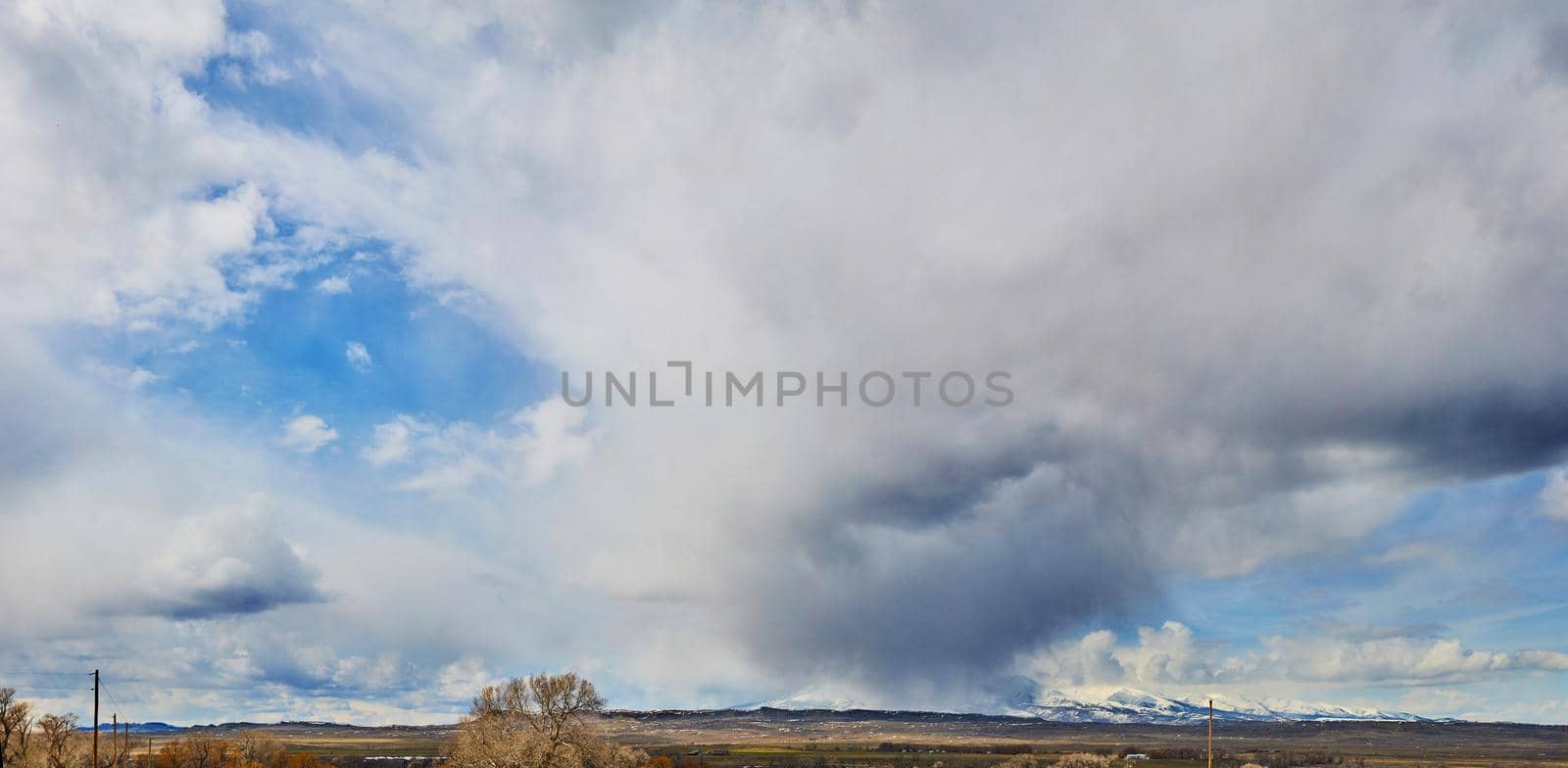 Image of Panorama of large storm overtaking snowy mountains