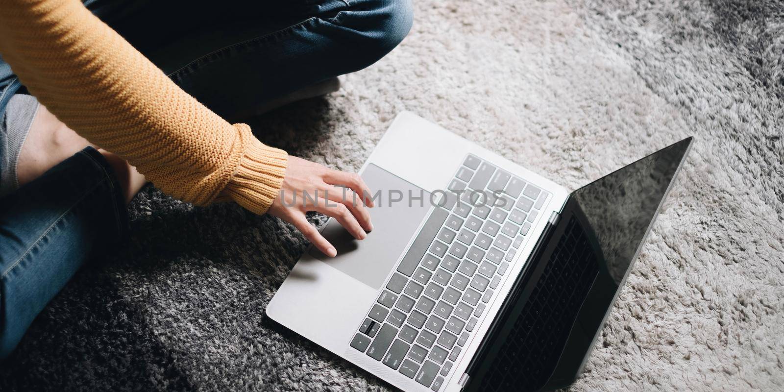 Closeup image of a business woman's hands working and typing on laptop keyboard at home