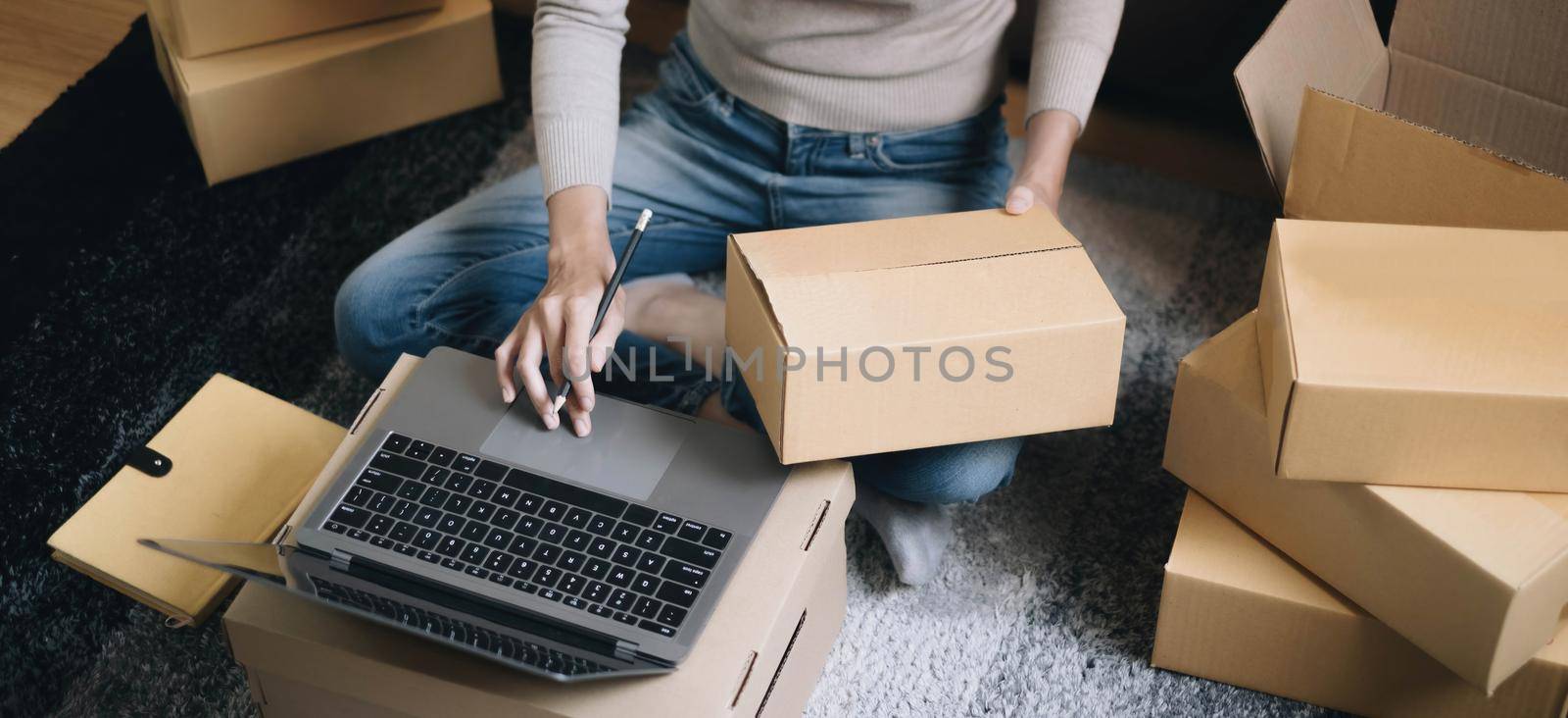 Starting small businesses SME owners female entrepreneurs Write the address on receipt box and check online orders to prepare to pack the boxes, sell to customers, sme business ideas online. by wichayada