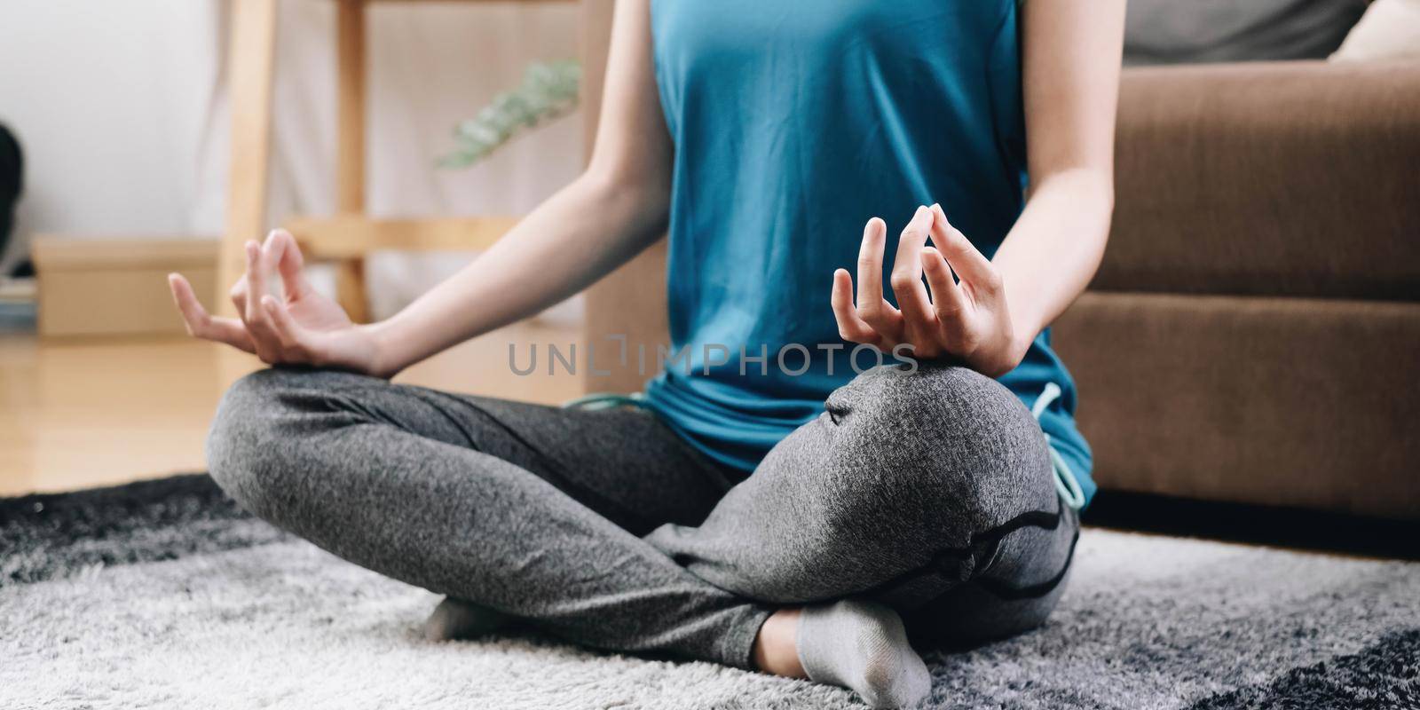 Class of yoga with meditate hands of Asia woman doing meditation Healthcare, lifestyle concept.National Physical Fitness and Sports Month. National Yoga Awareness Month by wichayada
