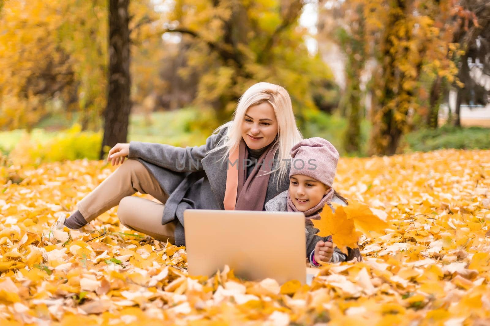 Autumn walk. mother and daughter are talking on video communication.