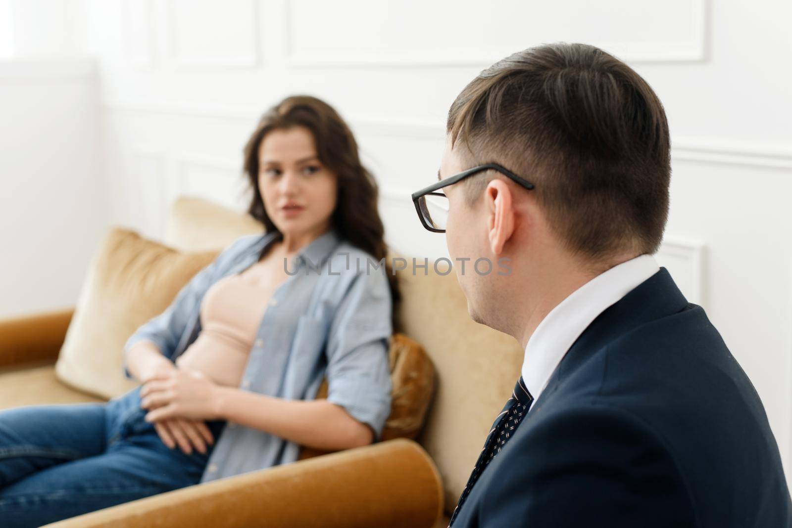 A young woman talks about her problems to a man psychologist. The concept of mental disorders. Selective focus.