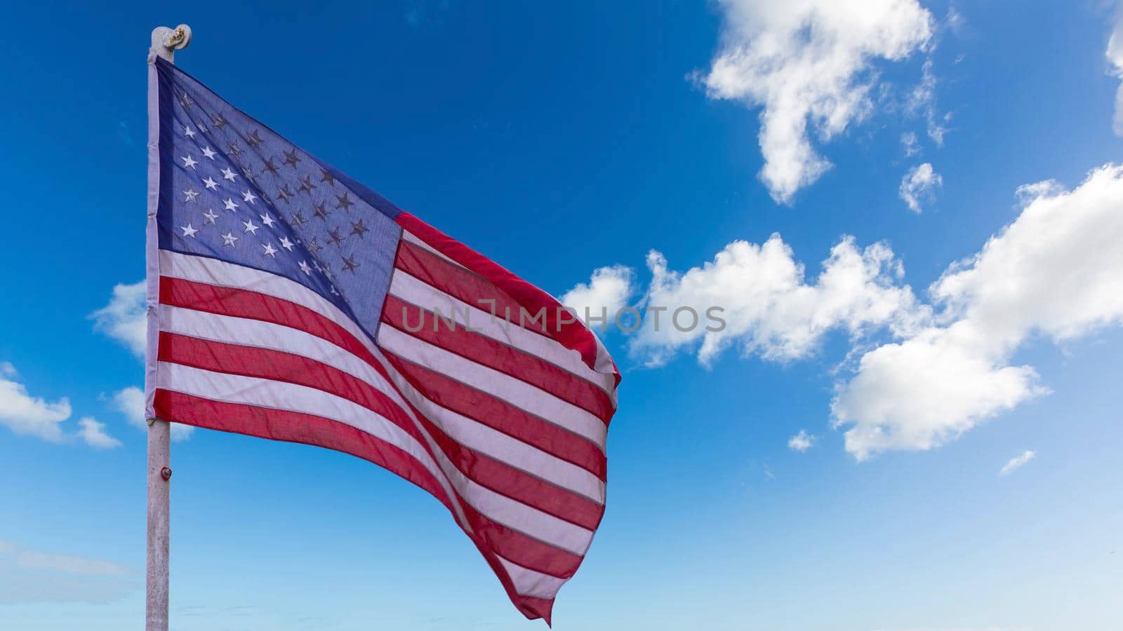 illustration of American Flag waving in sky backdrop by Andelov13