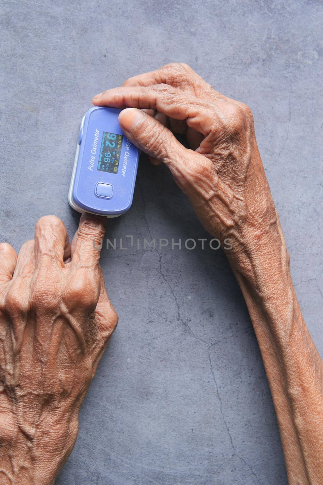 senior young women hand using pulse oximeter.