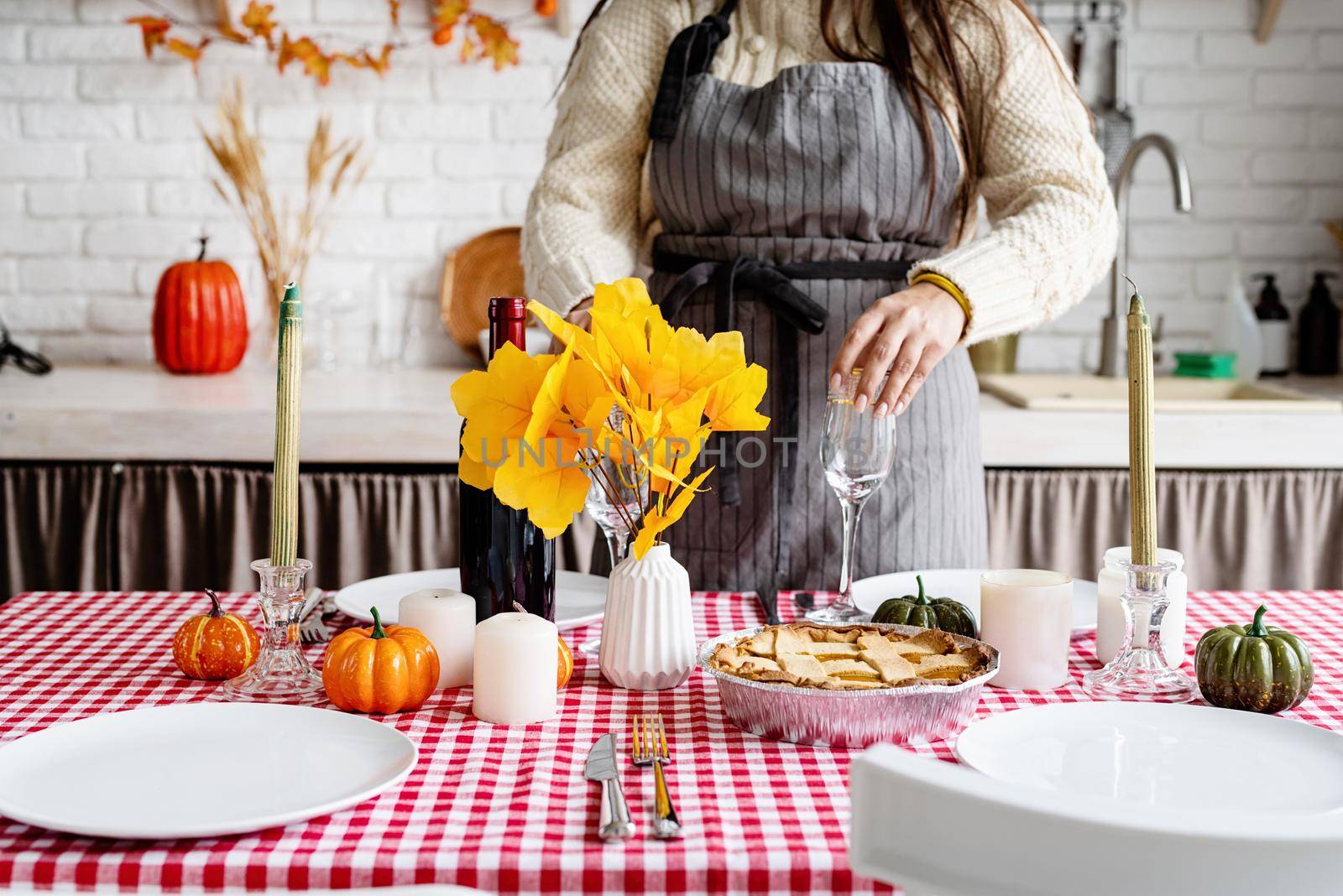 Portrait of a woman preparing thanksgiving dinner at home kitchen by Desperada