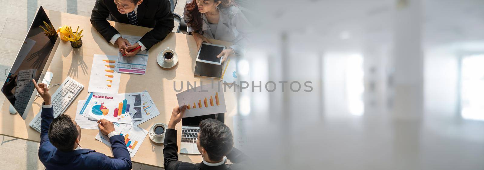 Business people group meeting shot from top widen view in office . Profession businesswomen, businessmen and office workers working in team conference with project planning document on meeting table .