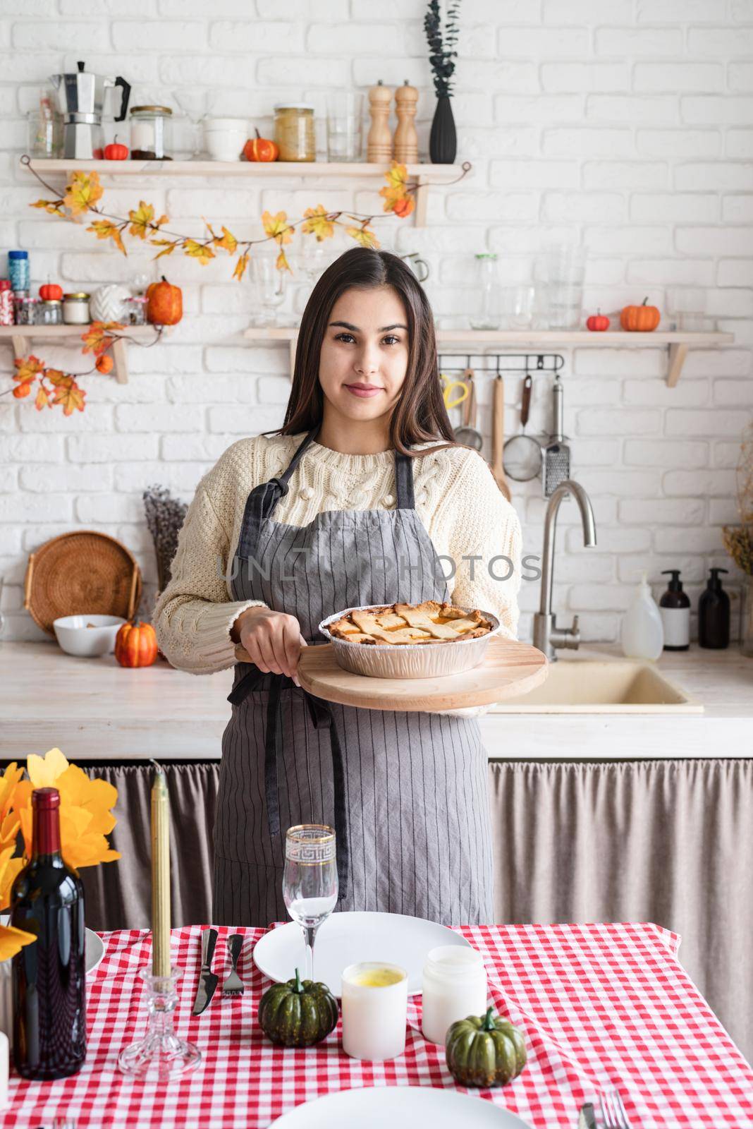 Happy Thanksgiving Day. Autumn feast. Woman celebrating holiday cooking traditional dinner at kitchen