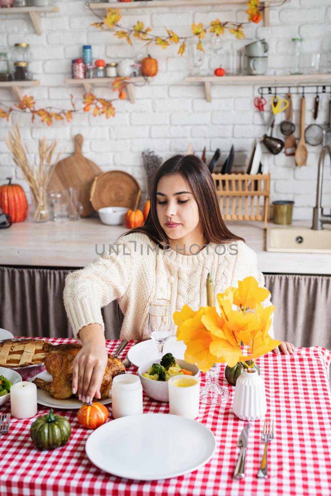 woman preparing thanksgiving dinner at home kitchen, decorating by Desperada