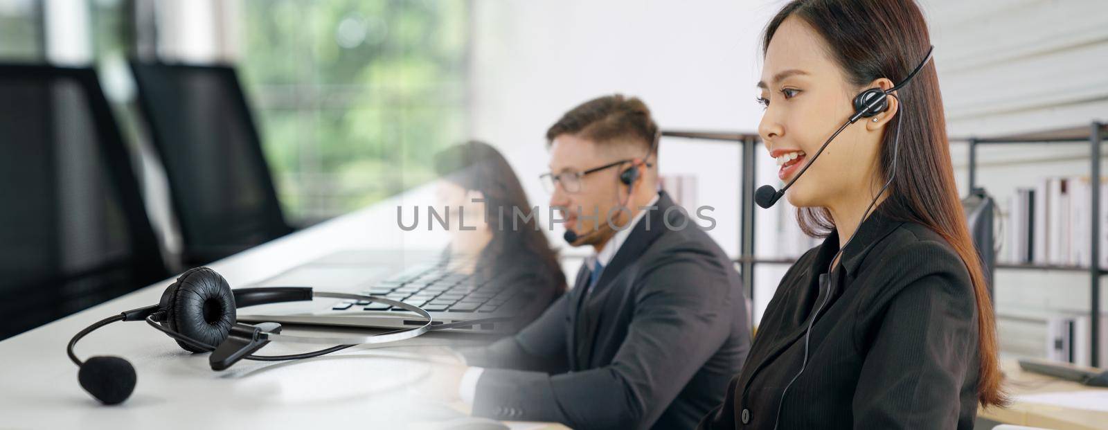 Business people wearing headset working in office to support remote customer or colleague. Call center, telemarketing, customer support agent provide service in broaden view .