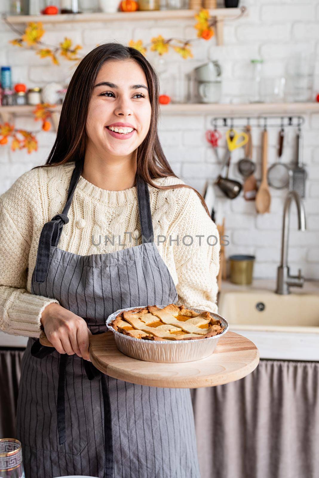 Happy Thanksgiving Day. Autumn feast. Woman celebrating holiday cooking traditional dinner at kitchen