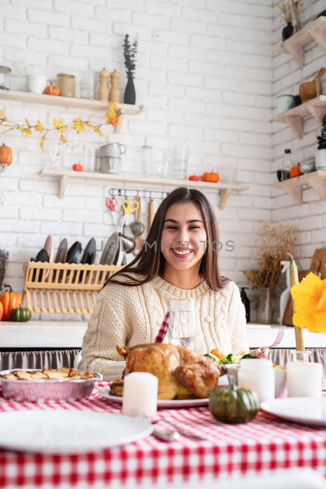 Happy Thanksgiving Day. Autumn feast. Woman celebrating holiday eating traditional dinner at kitchen