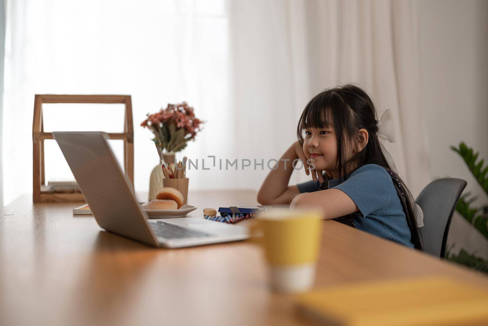 Asian Children girl using laptop computer for online study homeschooling. homeschooling, online study, home quarantine, online learning, corona virus or education technology concept by nateemee