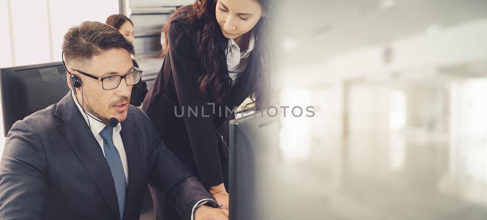 Business people wearing headset working in office broaden view by biancoblue