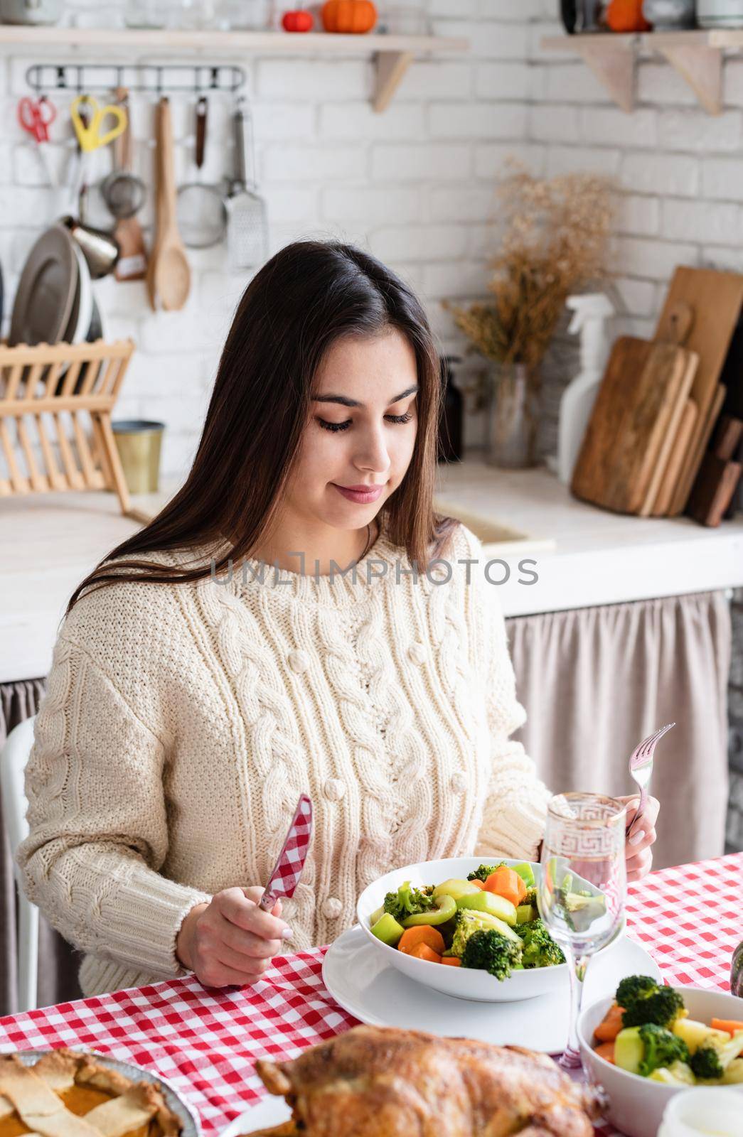 woman preparing thanksgiving dinner at home kitchen, decorating by Desperada