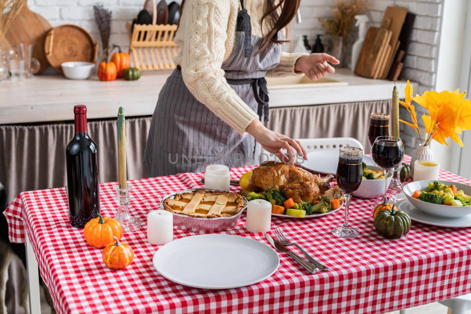 woman preparing thanksgiving dinner at home kitchen by Desperada