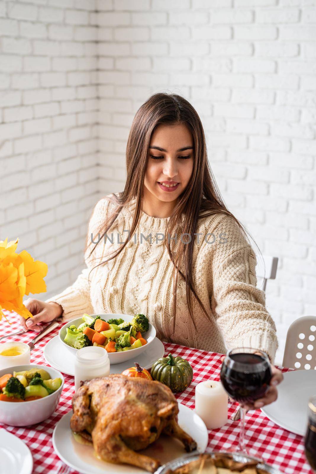 woman having thanksgiving dinner at home kitchen celebrating holiday by Desperada