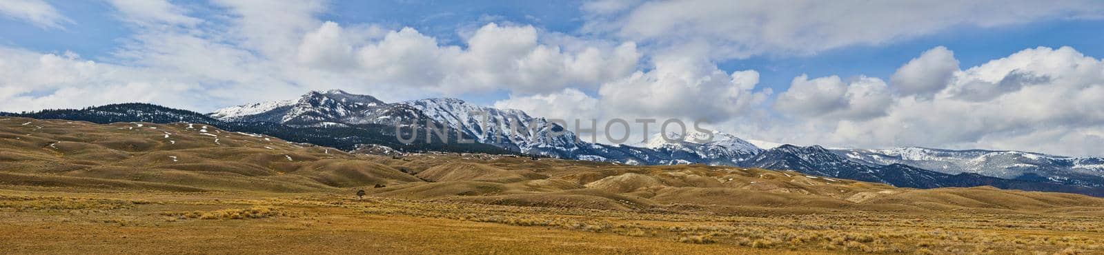 Panorama of fields in west lined with snowy mountains by njproductions