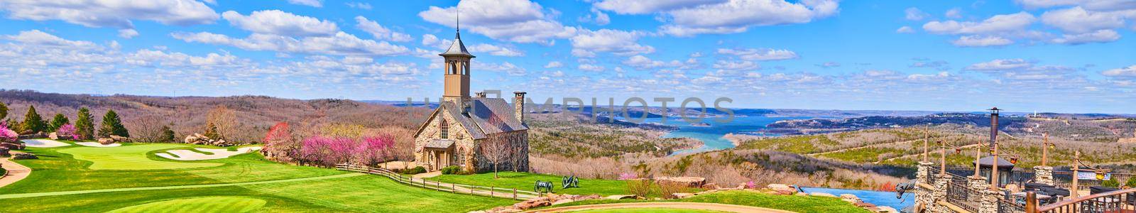 Stunning panorama of golf course and church on hills next to lakes in early spring by njproductions